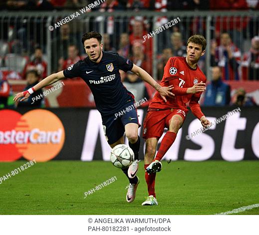 Munich's Thomas Mueller (R) in action against Madrid's Saul Niguez during the UEFA Champions League semi final second leg soccer match between Bayern Munich and...