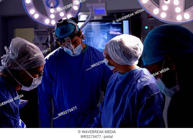 Surgeons talking with each other during surgery in operating room at hospital