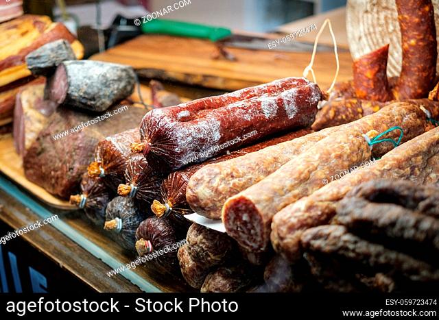 wurst, sausage and meat in shopping display at butcher
