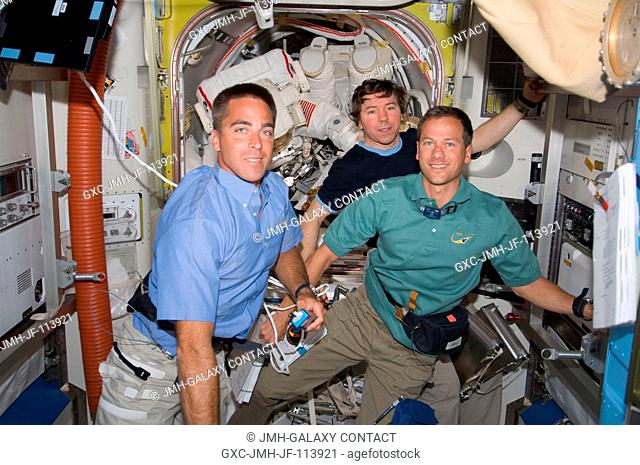 Two soon-to-be space-walking astronauts--Dave Wolf and Tim Kopra--although barely visible in the International Space Station's Quest airlock in the rear of this...