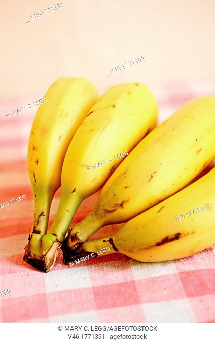 Bananas on red gingham cloth