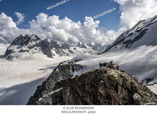 Switzerland, Arolla, Mountaineers standing at summit