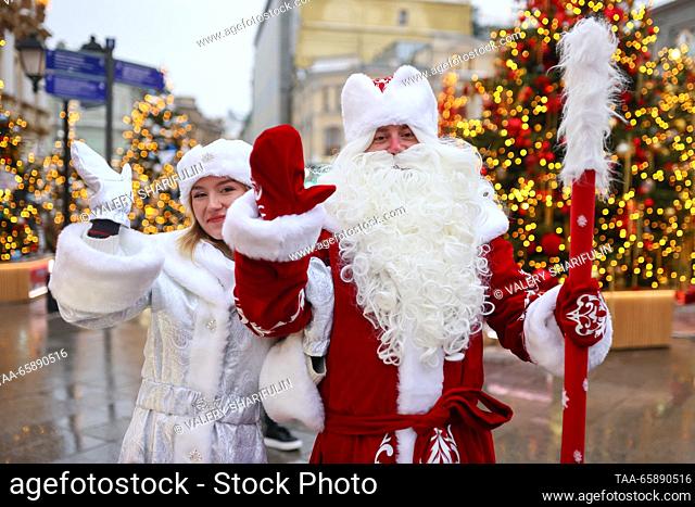 RUSSIA, MOSCOW - DECEMBER 19, 2023: People dressed as Father Frost (Russian Santa Claus) and Snow Maiden take part in the opening of an exhibition of designer...