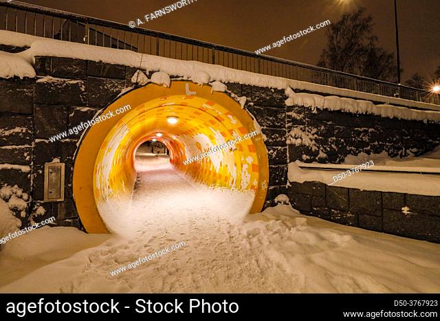 Stockholm, Sweden A yellow pedestrian tunnel in the snow in pedestrian in the Fruangen suburb