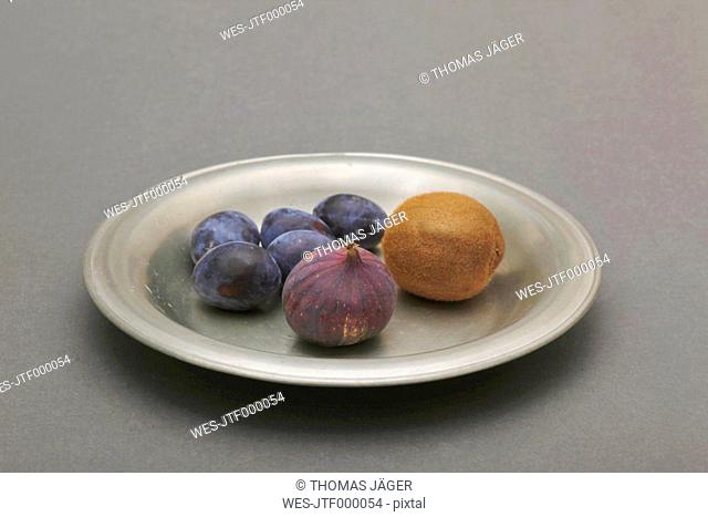 Plate of fruits on gray background