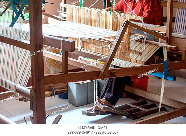 Woman working at the loom silk of thailand
