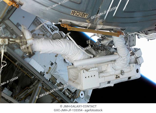 Astronaut Rex J. Walheim, STS-110 mission specialist, anchored to the mobile foot restraint at the end of the International Space Station's (ISS) Canadarm2