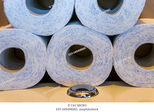 piled stack of toilet paper laying on the water closet, household products, bathroom background