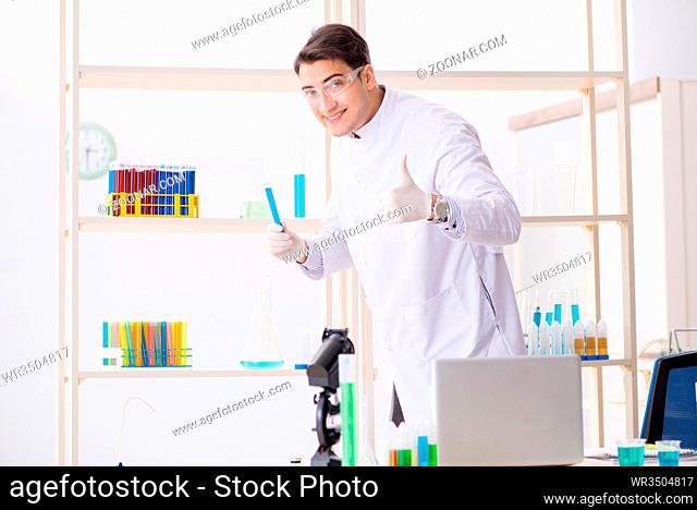 Man student working in chemical lab on experiment