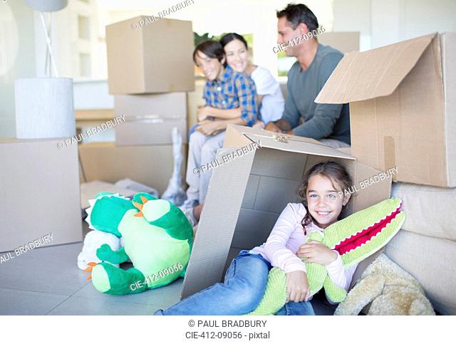 Family among cardboard boxes in livingroom