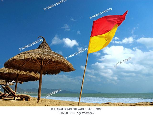 Sun shade at the 'Sailing Club' beach bar at Nha Trang's beach promenade Tran Phu, Vietnam