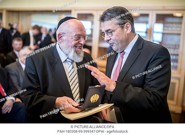 08 March 2018, Germany, Berlin: German Foreign Minister Sigmar Gabriel (R) of the Social Democratic Party (SPD) awarding the Order of Merit of the Federal...