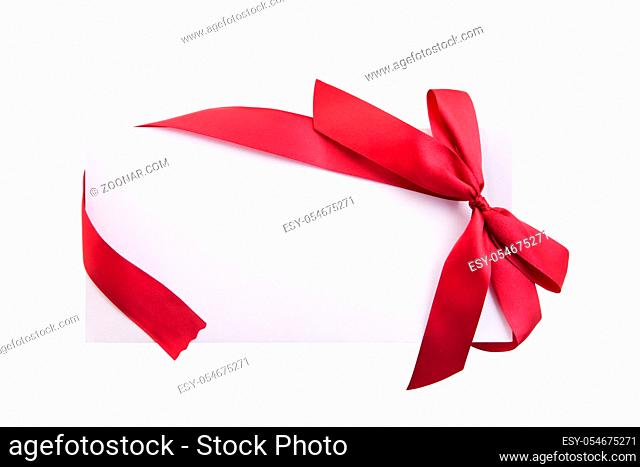 Close up of card note with red ribbon isolated on white background