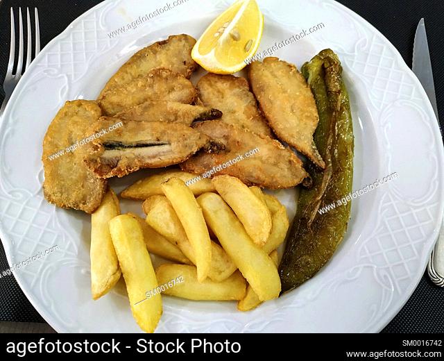 Breaded anchovies with pepper and potatoes at a restaurant. Borges Blanques, Lleida, Catalonia, Spain