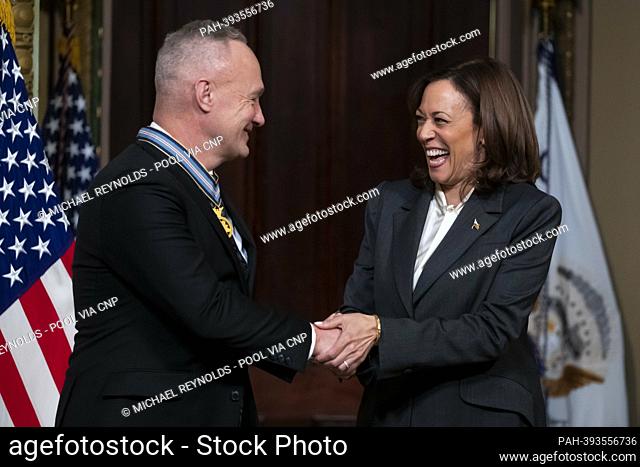 United States Vice President Kamala Harris (R) congratulates former NASA astronaut Douglas Hurley (L) after awarding him the Congressional Space Medal of Honor...