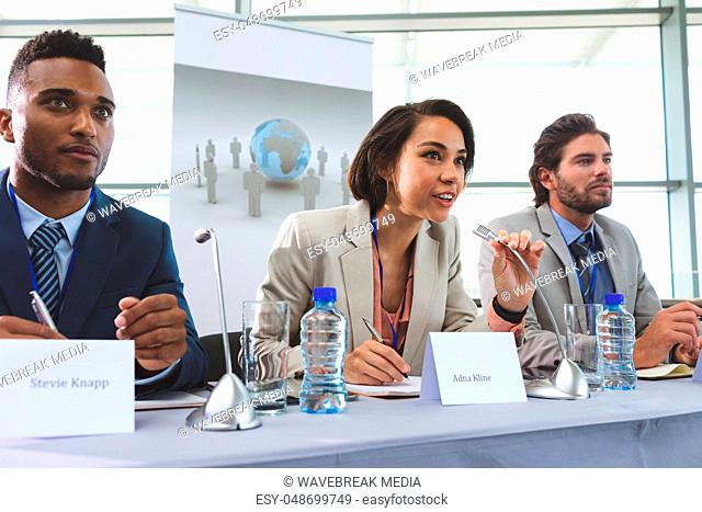 Business people sitting at table in seminar