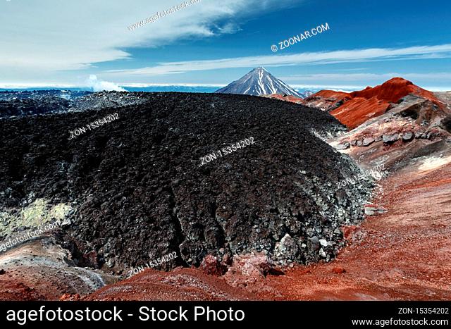 Scenery volcanic landscape of Kamchatka Peninsula - frozen lava field in summit colorful crater of active Avacha Volcano filled by eruption 1991