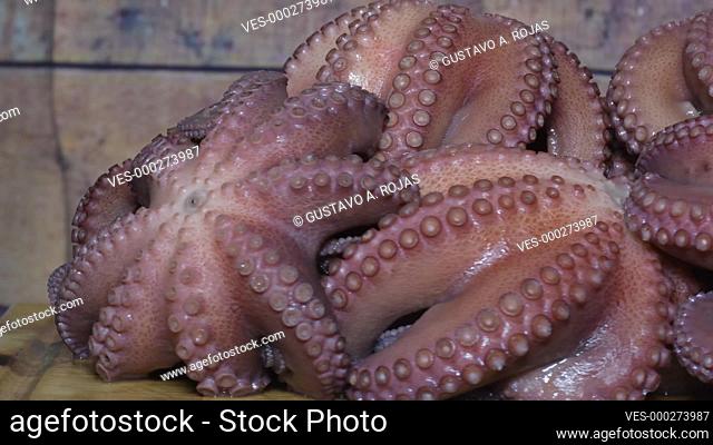 Hot big boiled octopus Freshly Prepared ROTATING ON wood TABLE