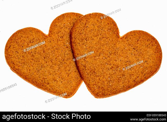 Two gingerbread cookies in a heart shape isolated on white background