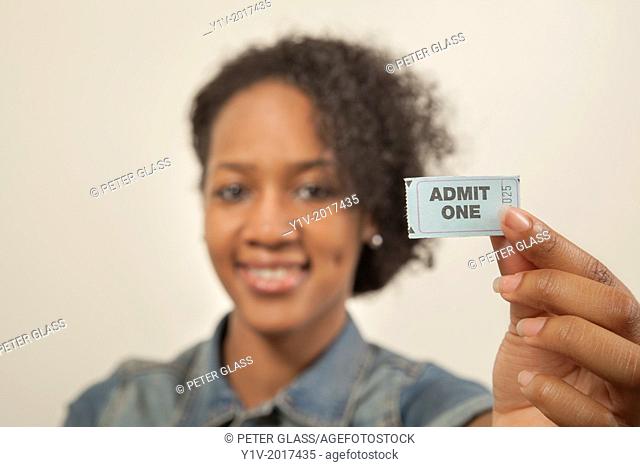Young black woman with a ticket reading, ""Admit One""