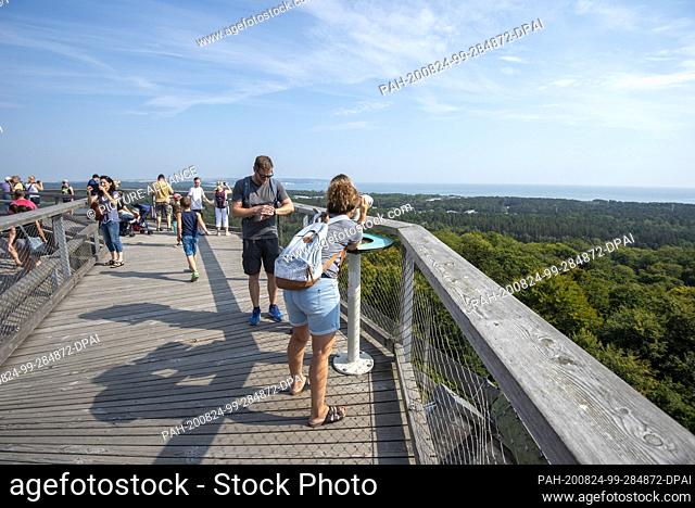 18 August 2020, Mecklenburg-Western Pomerania, Prora: Tourists enjoy the view from the 40-meter-high observation tower on the treetop path