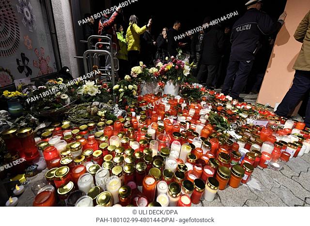 Flowers and candles are laid down in front of a drug store after a funeral march for a 15-year-old girl, who was stabbed by her boyfriend in the store on 27...