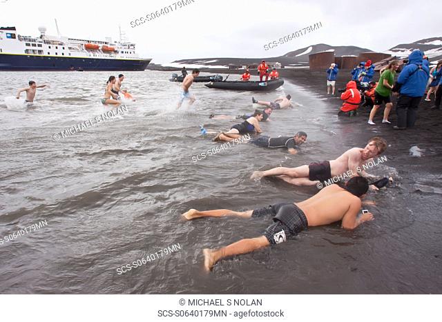 Guests from the Lindblad Expedition ship National Geographic Explorer lay in the relatively warm waters of the caldera at Deception Island