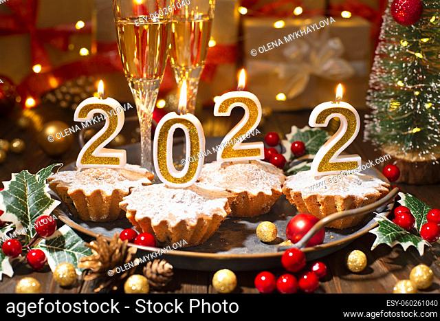Food tray with cupcakes new year candles and wineglasses