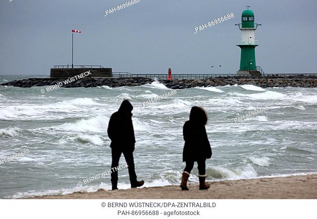 Walkers on a beach on the Baltic coast in Graal-Mueritz in northeastern Germany, 03 January 2016. Heavy storm tides have been forecast along the German Baltic...