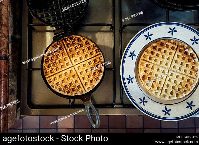 waffle iron with freshly baked waffle in the kitchen