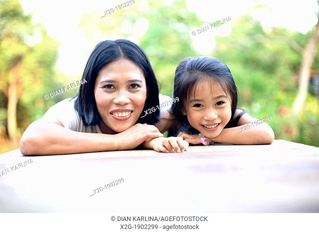 Mother and daughter playing in a garden