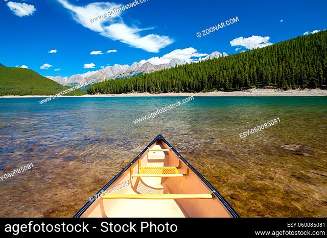 A single canoe on a mountain lake in the Canadian Rocky Mountains
