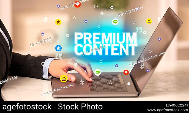 Freelance woman using laptop with PREMIUM CONTENT inscription, Social media concept