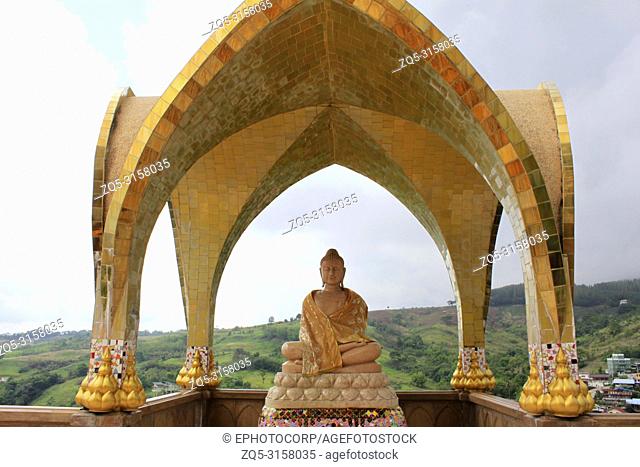 Smiling Buddha on one of the levels of Pha Sorn Kaew under a golden dome, at Pha Sorn Kaew, in Khao Kor, Phetchabun, Thailand