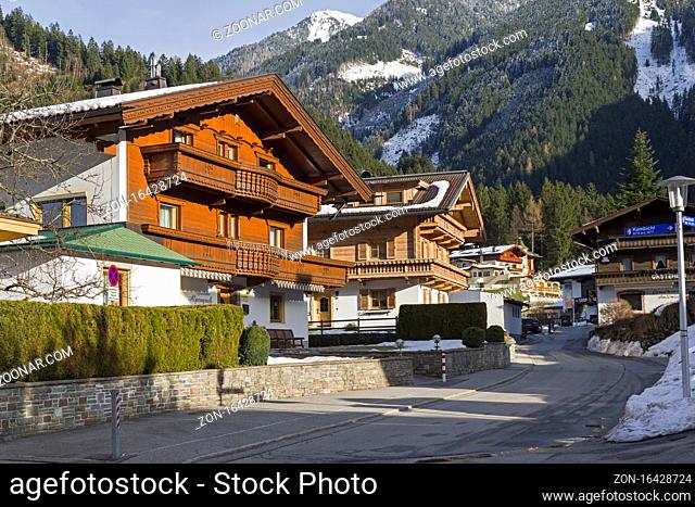 Modern houses in the ski resort of Mayrhofen, built in the traditional Tyrolean style. Tyrol, Austria. Sunny day in March