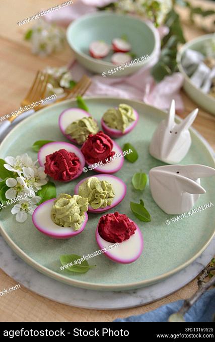 Stuffed Easter eggs on a wooden table flowers bunnies