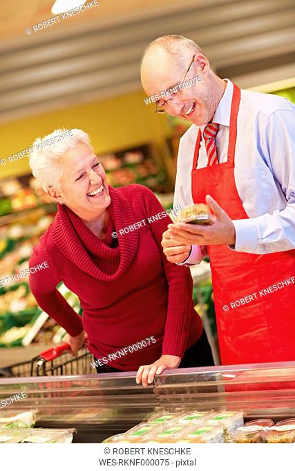 Germany, Cologne, Mature couple with premade salad in supermarket