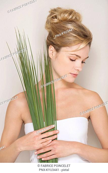 Beautiful woman holding wheatgrass