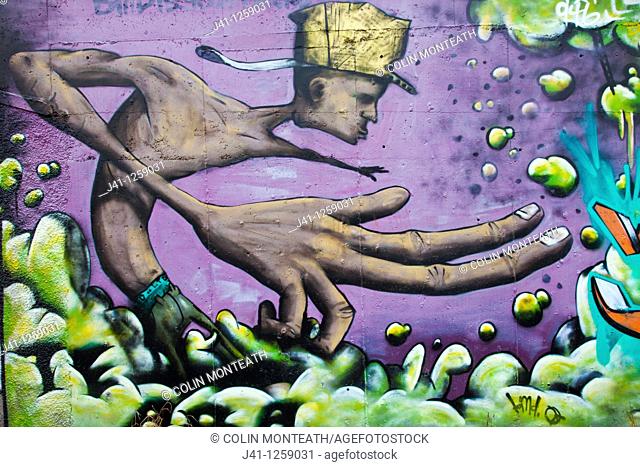 Street art, graffiti, adorns roadside wall, New Plymouth, taranaki