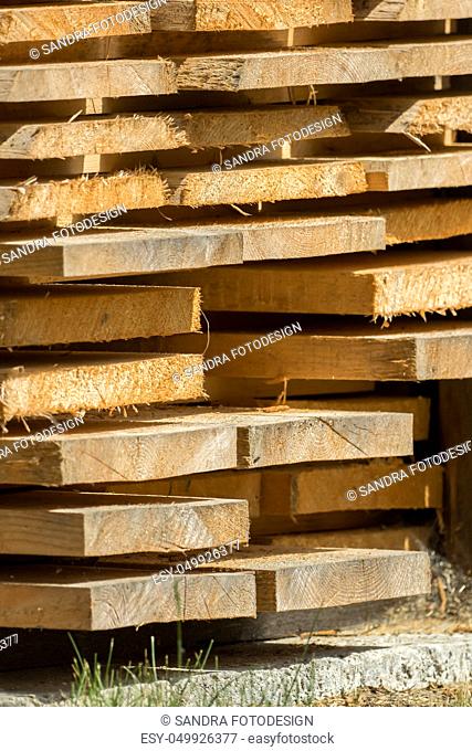Stacked wooden boards are waiting for processing