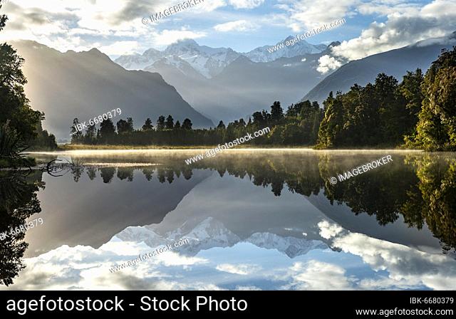 View of Mount Cook and Mount Tasman in morning light, reflection in Lake Matheson, Westland National Park, New Zealand Alps, West Coast Region, South Island