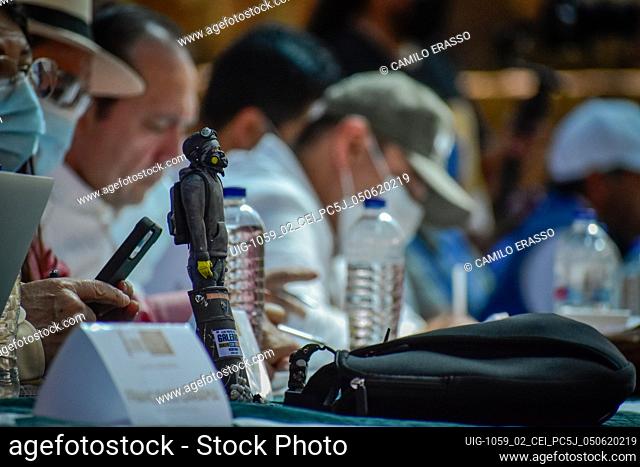 Members of the peace commission have on their table a sculpture of a member of the so-called front line during the public hearing convened by the Colombian...