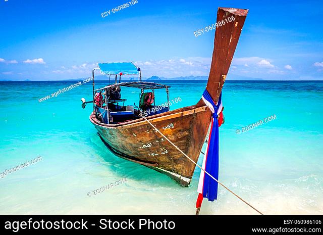 Longtail boat waiting for passengers on beautiful white beach in Bamboo Island near Ko Phi Phi, Thailand