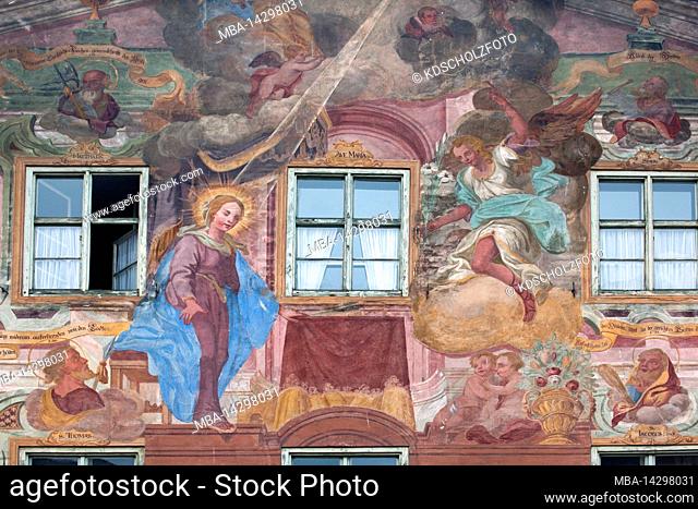 in a scene of the Annunciation to Mary, the angel brings Mary a white lily, biblical scene, Lüftlmalerei (traditional painting) on house facade in Mittenwald