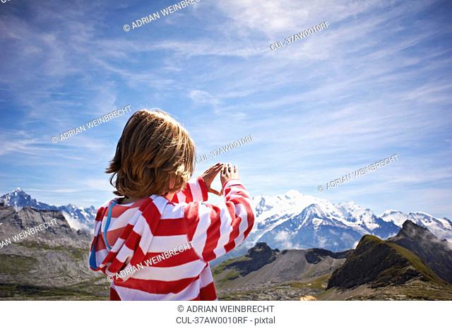 Boy admiring rocky landscape
