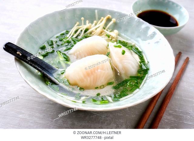 Traditional Japanese Gyoza Soup as close-up in a bowl