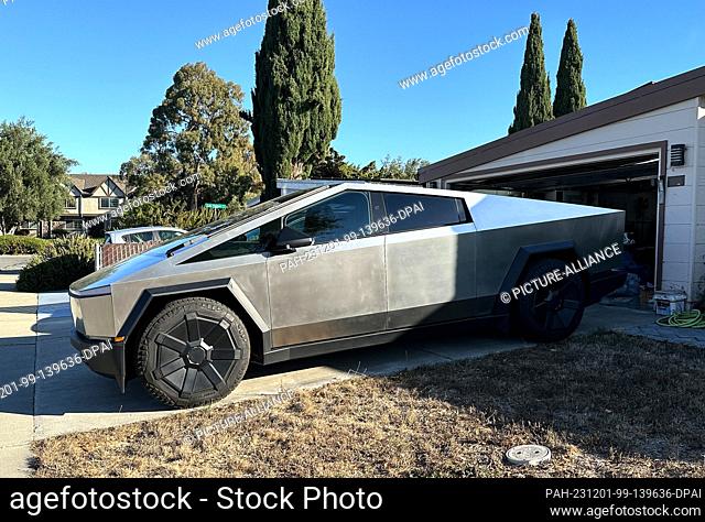 11 November 2023, USA, Santa Clara: A vehicle from Tesla's electric pickup ""Cybertruck"" series parked in front of a garage in Silicon Valley
