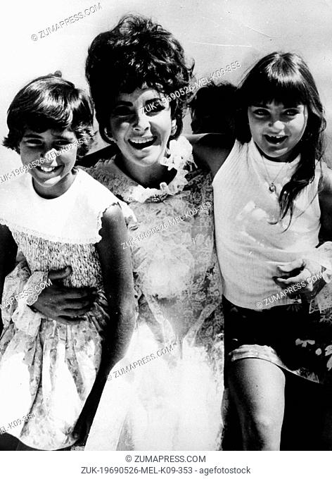 May 26, 1969 - New York, NY, U.S. - Actress ELIZABETH TAYLOR plays the role of mother, posing with her adopted child MARIA (L) and daughter LIZA (R)