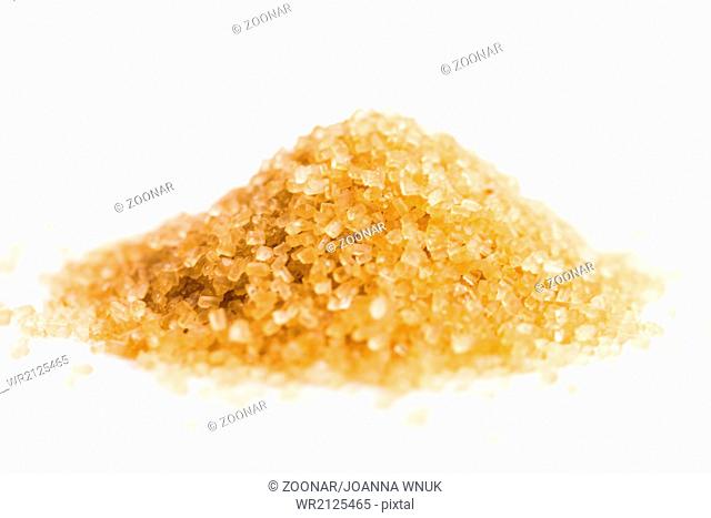 Crystals cane sugar heap close up isolated on white