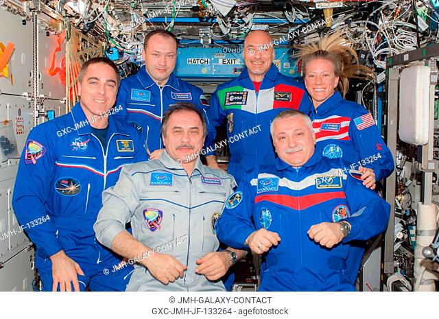 Expedition 3536 and Expedition 3637 crew members pose for a group portrait in the International Space Station's Destiny laboratory following the ceremony of...